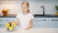 Little girl chooses food in the kitchen Royalty Free Stock Photo