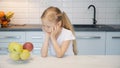 Little girl chooses food in the kitchen Royalty Free Stock Photo