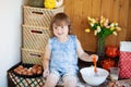 Funny little girl cooking pie in kitchen, kneading dough