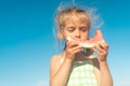 Funny little girl eat watermelon sunny summer day at ocean beach. Cute caucasian female child enjoy summer fruit bite slice of Royalty Free Stock Photo