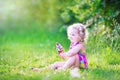 Funny little girl eating ice cream in the garden Royalty Free Stock Photo