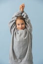 Funny little girl in a good mood wearing huge oversized grey longsleeve