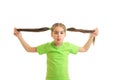 Funny little girl in green shirt holdin her tails in hands Royalty Free Stock Photo