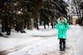 Funny little girl having fun in beautiful winter park Royalty Free Stock Photo