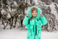 Funny little girl having fun in beautiful winter park Royalty Free Stock Photo