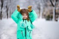 Funny little girl having fun in beautiful winter park Royalty Free Stock Photo