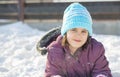 Funny little girl having fun in beautiful winter park during snowfall Royalty Free Stock Photo