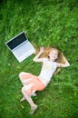 Funny little girl with laptop outside Royalty Free Stock Photo