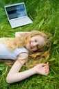 Funny little girl with laptop outside Royalty Free Stock Photo