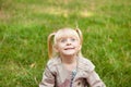 Funny little girl making faces outdoors in summer Royalty Free Stock Photo