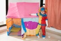 Funny little girl in multicolored clown wig costume