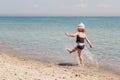 Funny little girl playing on the beach. Royalty Free Stock Photo