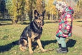 Funny little girl playing with a dog Royalty Free Stock Photo