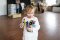 Funny little girl playing with pencils at the kindergarten Royalty Free Stock Photo