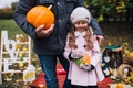 Funny little girl playing with pumpkin. Royalty Free Stock Photo
