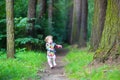 Funny little girl in rain boots walking in a park Royalty Free Stock Photo