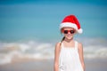 Adorable little girl in Santa hat on tropical beach Royalty Free Stock Photo