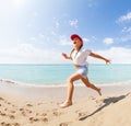 Funny little girl running and jumping on beach Royalty Free Stock Photo