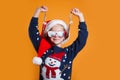 Funny little girl in Santa Claus hat and sunglasses having fun. Happy New Year and Merry Christmas Royalty Free Stock Photo