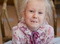 Funny little girl showing off her missing tooth