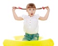 Funny little girl twitches his braids Royalty Free Stock Photo