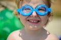 Funny little girl in water glasses Royalty Free Stock Photo