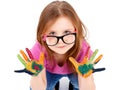 Funny little girl wearing glasses playing with water colors Royalty Free Stock Photo