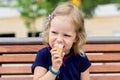 Funny little girl (3 years) eat ice cream. Royalty Free Stock Photo