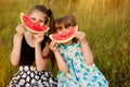 Funny little girls child eating watermelon in summer