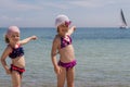 Funny little girls (sisters) on the beach at sailfish point.