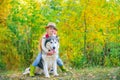 Funny little hugging cute dog pet. Dog friendly. Beautiful child girl playing with her dog. Autumn. Royalty Free Stock Photo