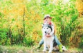 Funny little hugging cute dog pet. Dog friendly. Beautiful child girl playing with her dog. Autumn. Royalty Free Stock Photo
