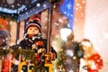 Funny little kid boy on a carousel at Christmas funfair or market, outdoors. Happy child having fun. Traditional xmas Royalty Free Stock Photo