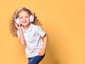 Funny little kid girl in white t-shirt isolated on yellow backgr Royalty Free Stock Photo