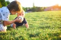 Funny little kids playing with ball on green grass on nature at summer day. Two brothers outdoors. Preschool boy and baby boy. Chi Royalty Free Stock Photo