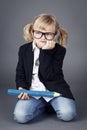 Funny little nerd holding big coloring pencil