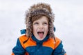 Happy kid boy having fun with snow in winter Royalty Free Stock Photo