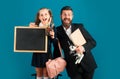 Funny little schoolgirl in school uniform having fun in studio. Portrait of amazed excited happy pupil school girl and Royalty Free Stock Photo