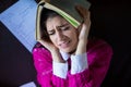 Funny looking brunette woman student trying to study in her room. Funny process of studying for exams