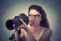 Funny looking young woman with digital camera Royalty Free Stock Photo