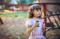 Funny lovely little girl blowing soap bubble