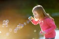 Funny lovely little girl blowing soap bubbles Royalty Free Stock Photo