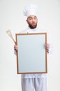 Funny male chef cook holding blank board