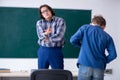 Funny male teacher and boy in the classroom Royalty Free Stock Photo