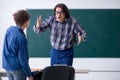 Funny male teacher and boy in the classroom Royalty Free Stock Photo
