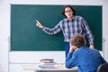 Funny male teacher and boy in the classroom Royalty Free Stock Photo