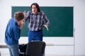 Funny male teacher and boy in the classroom Royalty Free Stock Photo