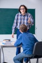 Funny male teacher and boy in the classroom Royalty Free Stock Photo