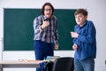 Funny male teacher and boy in the classroom Royalty Free Stock Photo