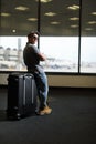 Funny man in airport with suitcase Royalty Free Stock Photo